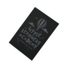 Black notebook with Little Learners Academy and a hot air balloon design on the cover.
