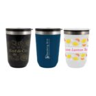 Three travel mugs: black, blue, and white with various designs and logos.