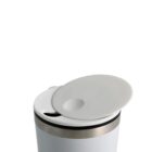 White mug with a gray lid slightly open against a plain background.