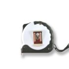 Close-up of a retractable tape measure with a black and white body and metal clip.