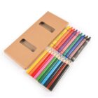 Crayons and colored pencils next to an open cardboard box with two rectangular windows.