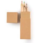 Four colored pencils in a brown box with the lid off, on a white background.