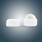 White lip balm container with cap off, on a gray background.