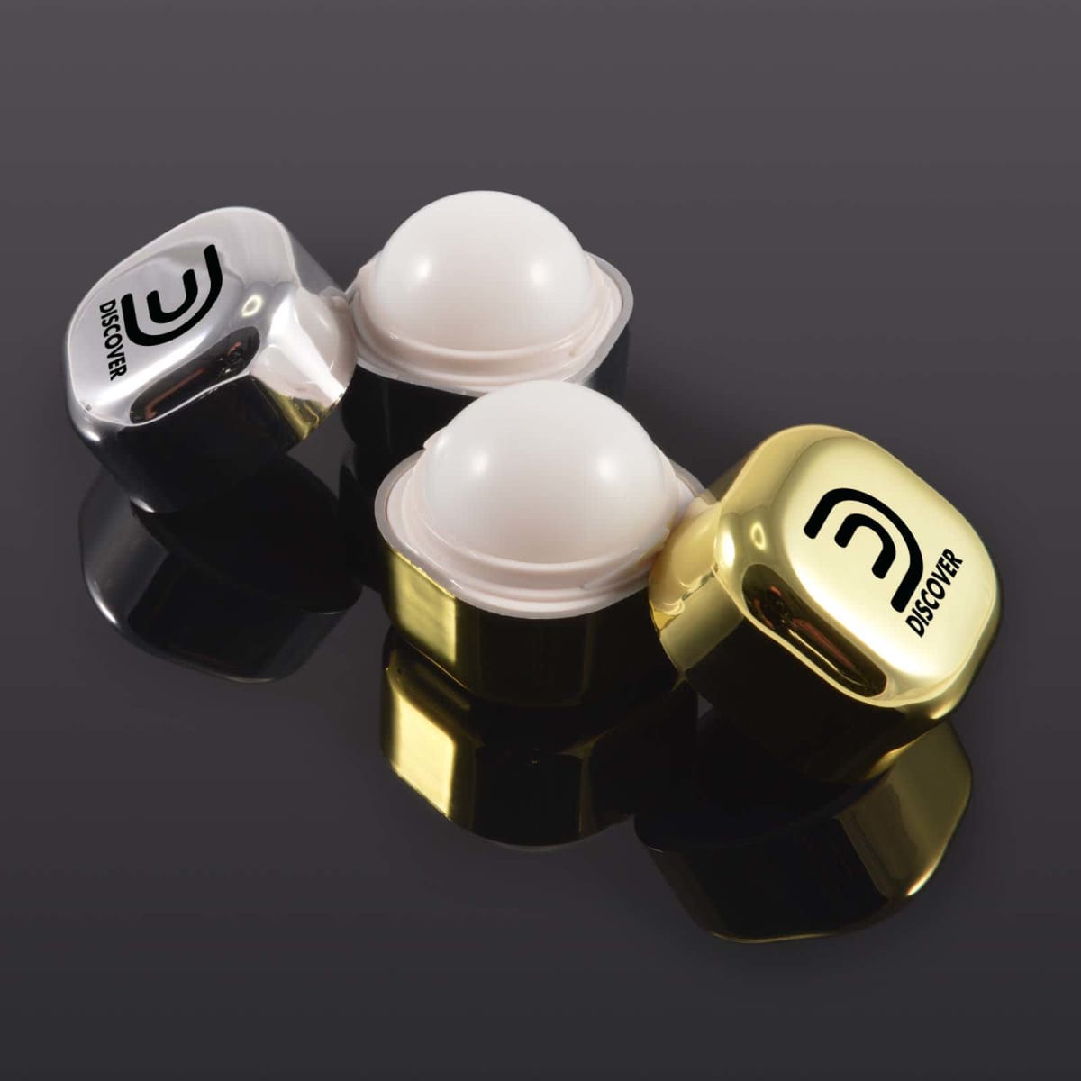 Two shiny earbud cases in silver and gold, with logo, on a reflective surface.