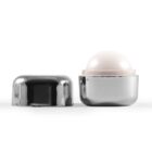 Silver lotion container with a sphere applicator lid beside it.