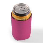 A soda can in a pink neoprene sleeve on a white background.