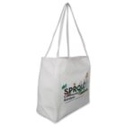 White tote bag with SPROUT Community Gardens and floral designs printed on the side.