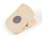 A beige magnetic clip with a silver circle, used for holding papers or sealing bags.