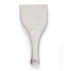 A beige plastic scraper with a hole in the handle, isolated on a white background.