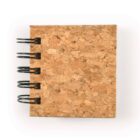 Square cork notebook with black spiral binding on a white background.