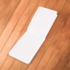 Open lined notebook on a wooden surface.