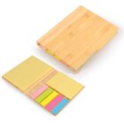 Bamboo notebook with sticky notes and colorful page markers displayed on and beside it.