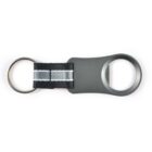 A bottle opener with a keyring and black strap featuring white stripes, on a plain white background.