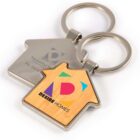 House-shaped keychains with colorful Desire Homes logo and contact details.