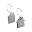 Two metal house-shaped keychains with CR Constructions logo on them.