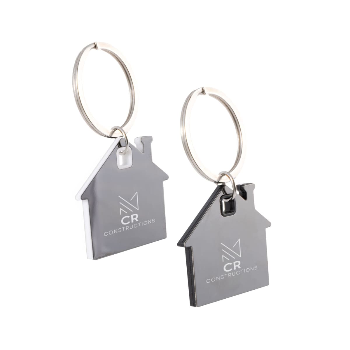 Two metal house-shaped keychains with CR Constructions logo on them.