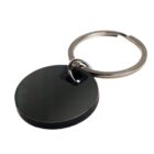 A black circular keychain with a metal ring attached.