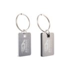 Two silver keychains with engraved EXPRESS RIDE RENTALS logos, showing a car silhouette design.
