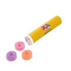 A yellow tube labeled KINDERWORLD with three colorful candy rings beside it.
