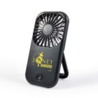 Black handheld fan with Honey Burgers logo in yellow, featuring a bee graphic, on a foldable stand.