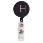 Black badge reel with Daring Harbor Hotel logo and attached clear strap clip.