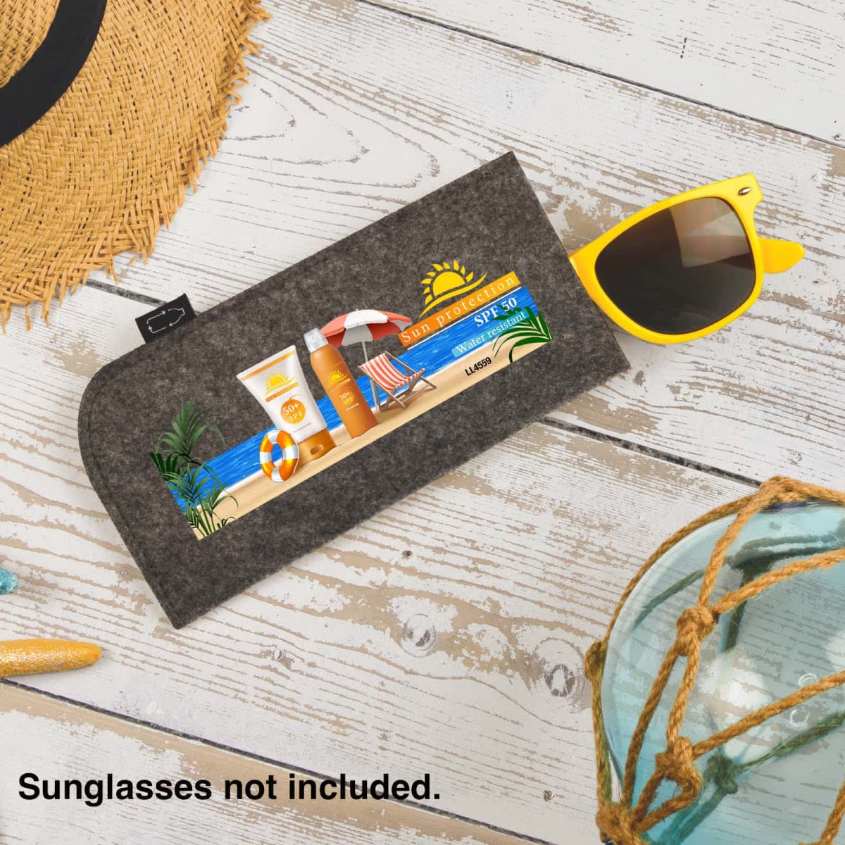 Beach-themed pouch on a wooden surface with sunglasses and a straw hat. Text reads, Sunglasses not included.