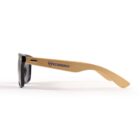 Sunglasses with black frames and light wood-like arms featuring the Ecoenergy logo on the side.