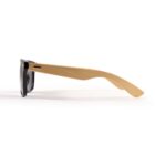 Sunglasses with black frames and wooden temples, side view on a white background.
