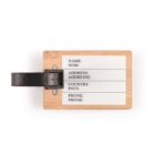Wooden luggage tag with fields for name, address, country, and phone number; features a black strap.