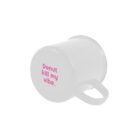 A white coffee mug with pink "Donut kill my vibe" text, lying on its side with the handle right.