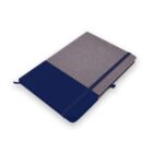 A closed two-tone notebook with navy blue and grey, elastic band, and ribbon bookmark.