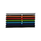 A stack of nine closed notebooks with colorful spines, including black, red, orange, white, green, blue, and navy. Each notebook is bound with an elastic band of the same color as its spine, arranged in a neat horizontal pile.