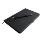 A closed black notebook with a black pen resting diagonally on its cover. The notebook has a built-in elastic band and a small ribbon bookmark visible on the left side.