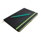 A closed black notebook with green elastic bands and a matching green ribbon bookmark lies on a surface. A teal pen with silver accents rests diagonally on top of the notebook.