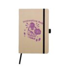A beige notebook with a black spine and elastic band. The front cover features a purple graphic with a light bulb and the text Innovative Hub Brain Dump.