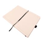 Open notebook with lined pages and a black ribbon bookmark lying across the center. The notebook has a smooth, light-colored cover and is positioned against a plain white background.
