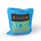A blue drawstring bag featuring the word ENIGMA in colorful letters above a yellow maze design.