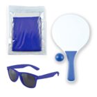 A set of items including a blue towel in a clear plastic bag, blue sunglasses, a white paddle with a blue handle, and a small blue ball, all arranged on a white background.