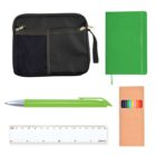 A flat lay image showing a black zippered pouch, a green notebook, a green pen, a set of colored pencils in a brown box, and a transparent ruler. All items are arranged neatly on a white background.