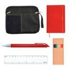 A collection of stationery items including a black pouch, a red notebook, a red pen, a set of colored pencils in a brown box, and a white ruler with measurements.