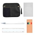A black pouch with zippers and a mesh pocket, a white notebook, a white pen with a silver tip, a clear ruler with measurements, and a brown box showing colored pencils.