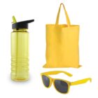 A yellow reusable water bottle with a straw, a yellow tote bag, and yellow sunglasses with dark lenses are arranged on a white background.