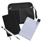 A black zippered pouch with mesh pockets, a black hardcover notebook, a translucent flat water bottle, and a white pen with black grip and silver tip are arranged on a white background.