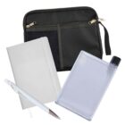 A black organizer pouch with zippers, a white notebook, a blue pen, and a flat, clear water bottle with a black cap are arranged together. The pouch has mesh pockets on the front, and the pen is placed diagonally on the notebook.