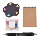 A small brown spiral notebook, a black pen, a colorful cloud-shaped sticky note pad, and a transparent bag of assorted jelly beans are arranged on a white background.