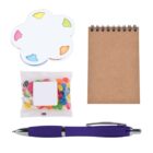 A set of office supplies and a snack: a cloud-shaped notepad with colorful tabs, a small brown spiral notebook, a bag of multi-colored jelly beans, and a purple pen with silver accents.