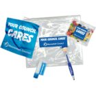 Clear pouch with Your Council Cares branding contains a cleaning cloth, jelly beans, blue pen, lip balm, and magnifier, all with Mooranbah Council logo.