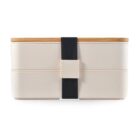 A beige, two-tiered bento lunch box with a black elastic strap securing its wooden lid. The minimalist design highlights simplicity and functionality.