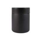 A matte black cylindrical container with a matching lid, set against a plain white background. The jar is simple and sleek, suggesting a modern design, and is likely used for storing cosmetics or personal care products.