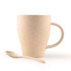 A beige ceramic mug with a speckled pattern, featuring a curved handle, sits next to a matching spoon. Both are set against a plain white background.